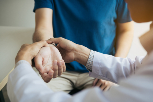 Physical,Therapist,Checks,The,Patient,Wrist,By,Pressing,The,Wrist